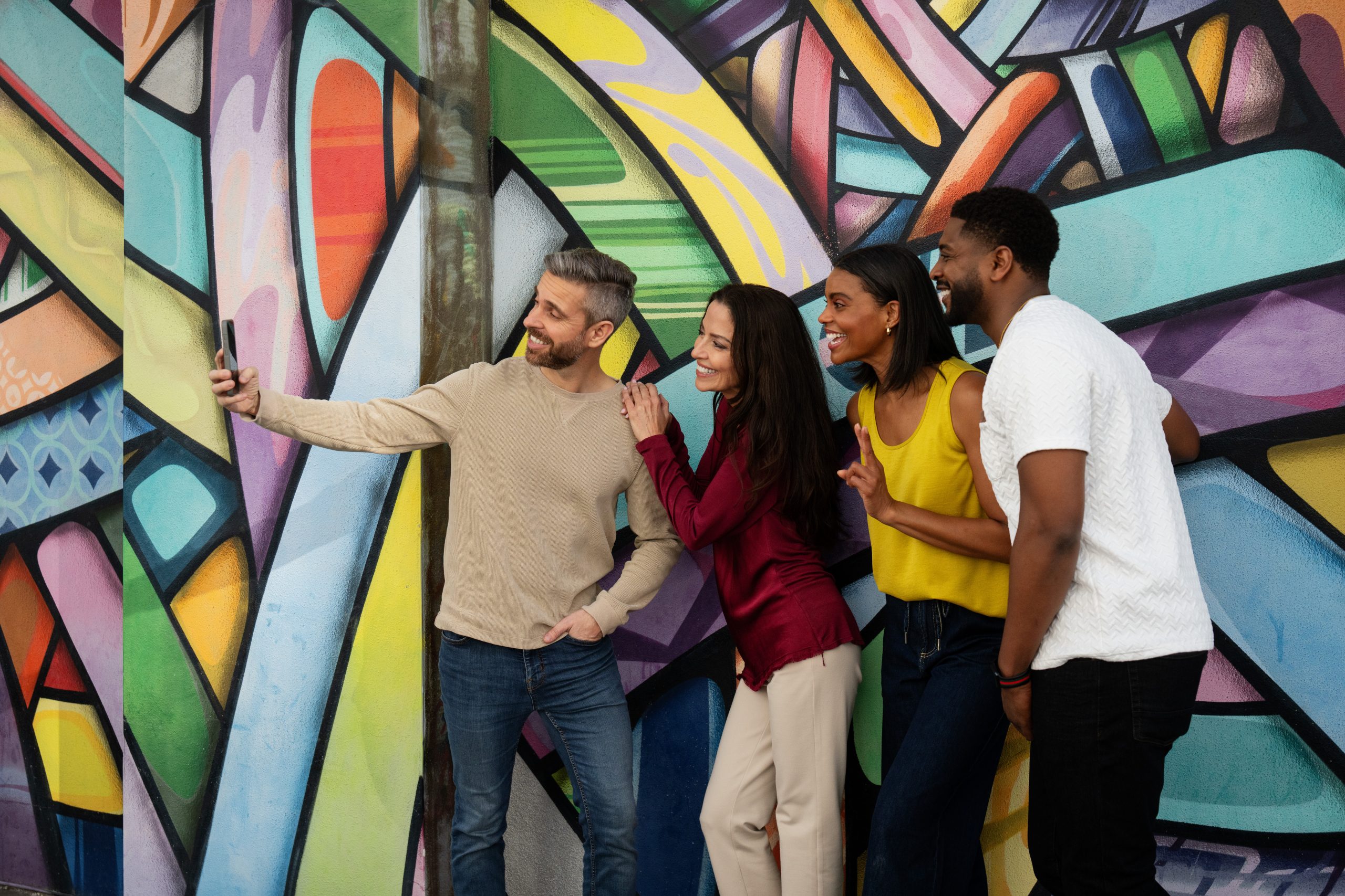 Group of 4 people taking a selfie outside of park near VIV St. Pete